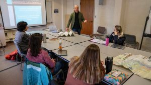 A photo of John Bear Mitchell teaching a lecture